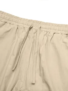 Close-up detail of elastic waist and adjustable drawstring on men's casual linen pants