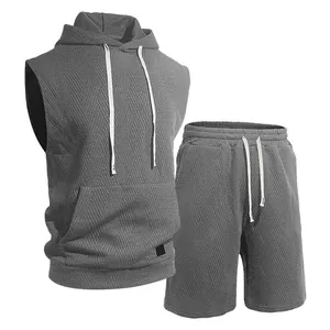 Detailed macro view of men's gray knitted jacquard sleeveless hoodie and shorts set
