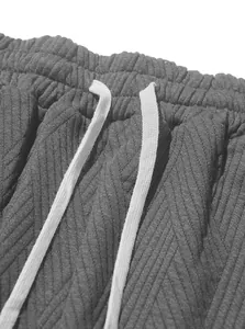 Close-up detail of grey knit jacquard fabric and white drawstring on men's sports shorts
