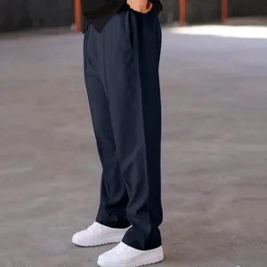 Close-up of men's navy blue textured straight-leg casual pants with drawstring waist.