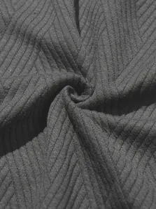 Close-up detail of textured jacquard knit fabric showing ribbed pattern for men's sports set