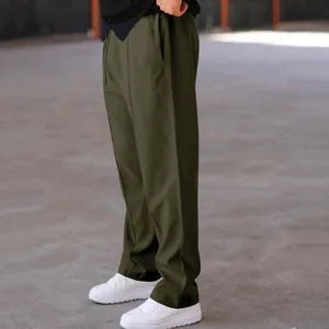 Side view of olive green loose straight-cut casual drawstring trousers for men's daily wear