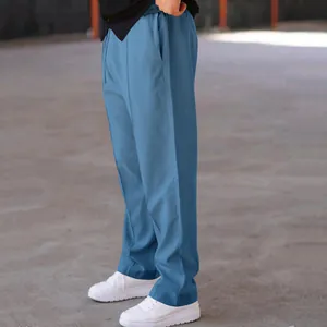 Side view of blue textured straight leg trousers for men with elastic drawstring waist