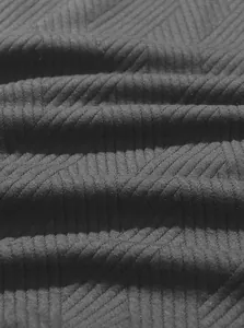 Close-up macro detail of the premium black jacquard ribbed knit fabric showing texture