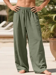 Detailed view of men's olive green linen pants with drawstring waist in resort setting