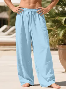 Men's loose-fit light blue linen trousers with adjustable drawstring waist for beach or leisure