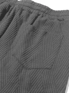 Macro view of men's textured jacquard knit sports shorts fabric showing pocket details