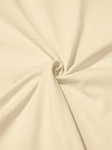 Macro detail shot of beige breathable quick-dry fabric showing smooth knitted texture