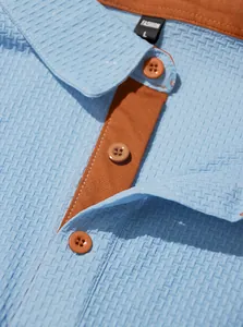 Close-up of men's ice-feel polo shirt showing blue waffle texture and orange trim