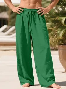 Detailed view of green men's linen casual trousers featuring drawstring waist and soft texture