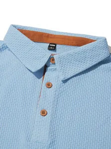 Close-up of light blue textured Polo shirt collar with brown buttons and lining