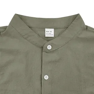 Close-up shot of men's olive green linen shirt stand collar and size M tag detail