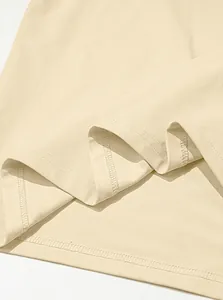 Close-up detail of the double-stitched hem on a beige quick-dry men's athletic t-shirt