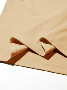 Close-up of high-quality stitching and beige fabric texture on a men's Henley shirt.