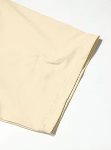 Detail view of double-stitched sleeve hem on a beige breathable sports T-shirt.