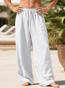 Close-up detail of men's loose-fitting white linen drawstring casual trousers for summer