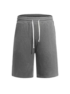 Close-up of men's grey knit shorts featuring a diagonal jacquard textured pattern.