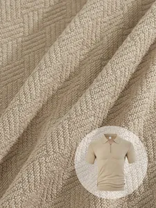 Close-up macro view showing the intricate texture of beige towel jacquard polo shirt fabric.
