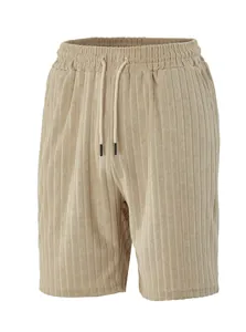 Close-up of beige ribbed casual shorts showing elastic drawstring waist and texture
