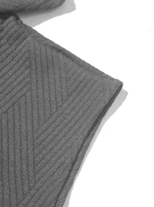 Close-up of grey ribbed jacquard knit fabric showing detailed texture and seam quality