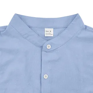 Close-up detail of a light blue men's linen shirt showing collar, buttons, and size label