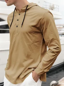 Close-up of men's khaki hooded long sleeve Henley shirt with black drawstring