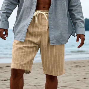 Close-up of men's striped linen-like shorts shown in a relaxed beach holiday setting