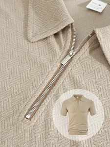 Close-up detail of men's towel jacquard polo shirt with silver zipper and texture