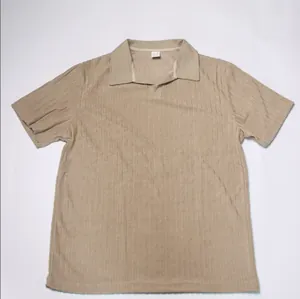 Detailed flat lay of a khaki vertical striped jacquard knit polo shirt for men