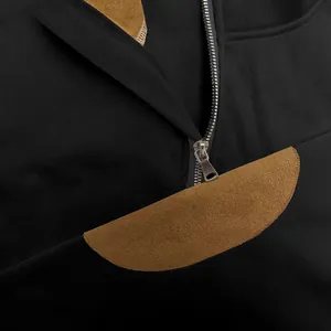 Close-up detail of men's half-zip sweatshirt with brown suede patch and fleece collar