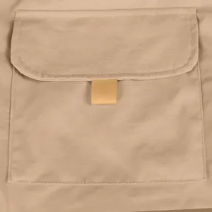 Macro detail shot showing the durable cargo pocket construction on khaki cotton shorts