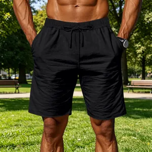 Detail view of men's black cotton linen drawstring casual shorts for outdoor sports.