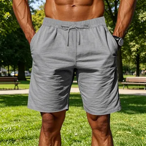 Close-up of men's gray cotton linen sports shorts with drawstring waist in a park
