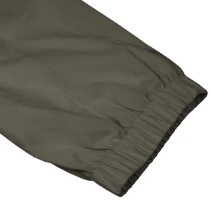 Close-up detail of the durable elastic cuff on olive green outdoor cargo pants