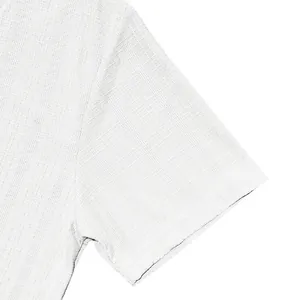 Detailed macro view of white faux linen slub fabric texture on a casual short sleeve shirt