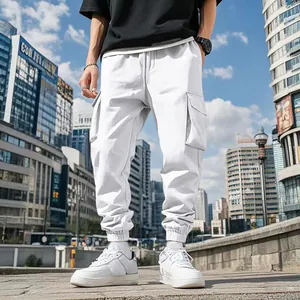 Detail view of mens white outdoor cargo pants with multiple pockets and elastic cuffs