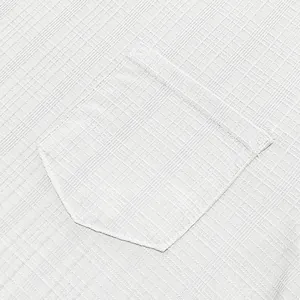 Close-up detail of white linen-like textured fabric and chest pocket on men's t-shirt