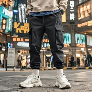 Close-up of men's black multi-pocket cargo pants in a trendy urban streetwear style.