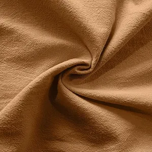 Macro view of breathable brown linen fabric texture showing the natural weave pattern.