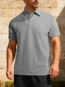 Detail of men's grey short-sleeve polo shirt featuring a unique jacquard texture.