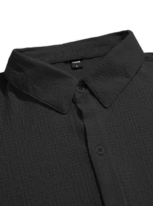 Close-up detail of black textured short-sleeved men's shirt showing collar and buttons