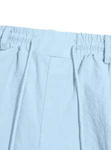 Detail view of the elastic drawstring waistband on these light blue cotton linen casual shorts