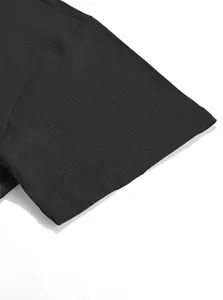 Close-up of black textured fabric on short sleeve men's shirt