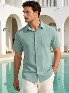 Close-up of a man wearing a mint green textured short-sleeve button-down casual shirt