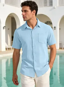 Detail shot of light blue textured short sleeve men's shirt in a summer pool setting