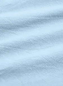Macro view of breathable light blue cotton-linen fabric texture for men's shorts