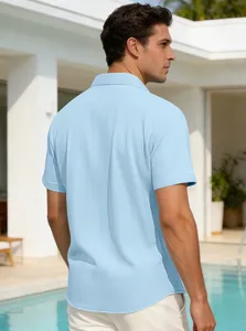 Rear view of light blue waffle texture polo shirt for men in casual outdoor pool setting