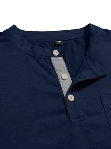 Close-up of navy Henley collar featuring a grey placket and white buttons on men's shirt