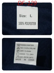 Detailed view of the clothing care labels and size tag on a navy blue jacquard fabric polo