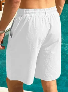 Detailed back view of men's white breathable cotton linen casual beach shorts by the pool